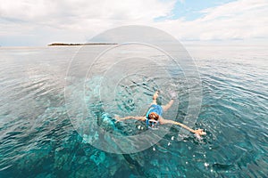 Woman snorkeling on coral reef tropical caribbean sea, turquoise blue water. Indonesia Wakatobi archipelago, marine national park