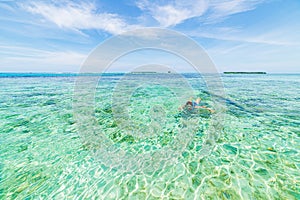 Woman snorkeling on coral reef tropical caribbean sea, turquoise blue water. Indonesia Wakatobi archipelago, marine national park