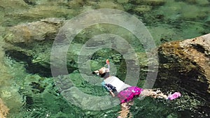 Woman snorkeling in Elba island Sant` Andrea beach