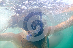 Woman, snorkeling and swimming on holiday in water, sport and diving for travel, fun and activity. Scuba, diver and mask