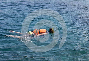 Woman snorkelling in andaman sea at phi phi islands, Thailand photo