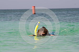 Woman snorkles in the caribbean