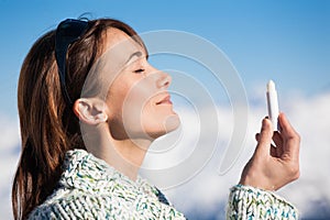 Woman on the snow applying a protective cream