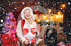 Woman in snow. New year girl. Sexy Santa Clause woman in elegant dress. Christmas preparation. Fashion portrait of model