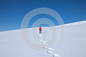 Woman snow-shoeing in the mountains