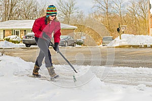 Woman Snow Shoveling Driveway