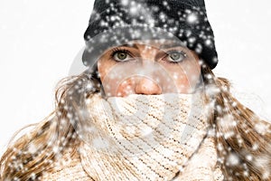 Woman in the Snow with winter wearing, wrapped in winter cap and scarf looking cold isolated on white background