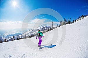 Woman on a snowboard in the mountains Sheregesh