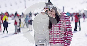 Woman with snowboard relaxing on holiday