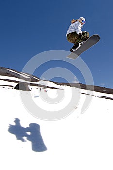 Woman snowboarder jump shadow