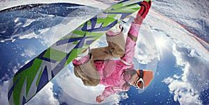 Woman snowboarder jumping