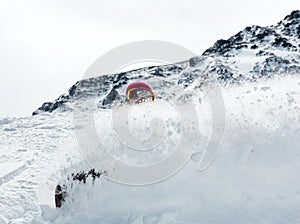 Woman snowboarder in motion in mountains