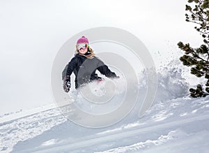 Woman snowboarder in motion in mountains