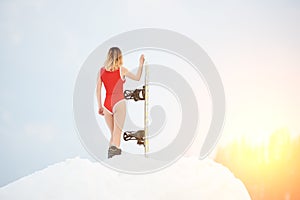 Woman snowboarder with snowboard on snowy slope at winter ski resort