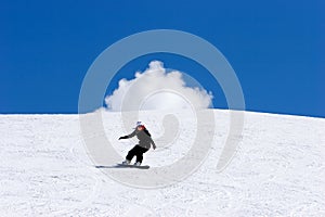 Woman snowboarding on slopes of Pradollano ski resort in Spain