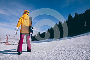 Woman snowboarding in winter mountains