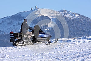 Woman on snowmobile photo