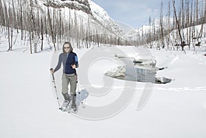 Woman snowshoeing in the Canadian rockies