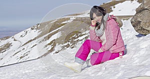 Woman on snowy mountain slope