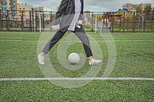 woman soccer player with ball on the field. ball dribbling, feint.