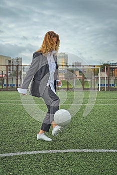 woman soccer player with ball on the field. ball dribbling, feint.