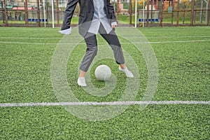 woman soccer player with ball on the field. ball dribbling, feint.