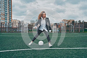 woman soccer player with ball on the field. ball dribbling, feint.