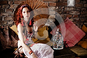 Woman on sofa with parasol photo