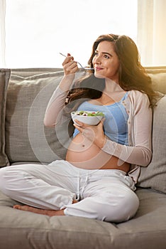 Woman, sofa and pregnant with salad for eating with healthy diet in living room with smile for relax with maternity