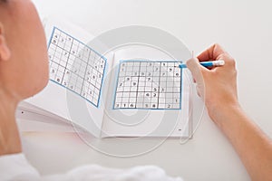 Woman solving sudoku