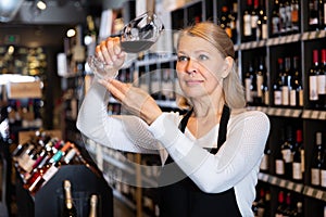 Woman sommelier tasting wines in winery
