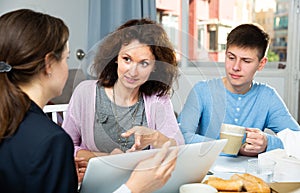 Woman with son meeting with tutor