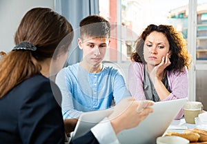 Woman with son meeting with tutor