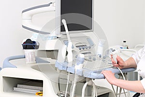 Woman sonographer using ultrasound machine at work