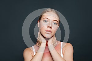 Woman with sore throat on gray background. Flu epidemic concept