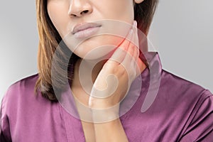 Woman with a sore throat holding her neck