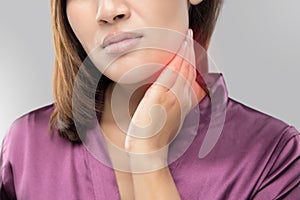 Woman with a sore throat holding her neck photo