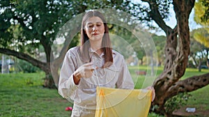 Woman sorting recyclables park showing environmentalism closeup. Conservationist