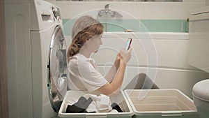 A woman sorts laundry before washing.