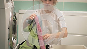 A woman sorts laundry before washing.