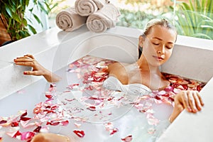 Woman Spa Flower Bath. Aromatherapy. Relaxing Rose Bathtub. Beauty