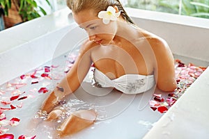 Woman Spa Flower Bath. Aromatherapy. Relaxing Rose Bathtub. Beauty