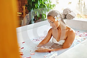 Woman Spa Flower Bath. Aromatherapy. Relaxing Rose Bathtub. Beauty