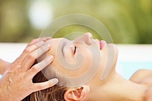 Woman, spa and head massage with therapist for wellness, holistic therapy and reiki at holiday resort. Beauty, skincare