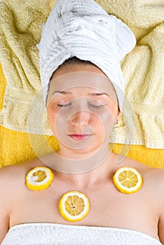 Woman at spa with lemon on skin
