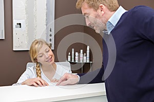 Woman in spa recpetion talks to customer