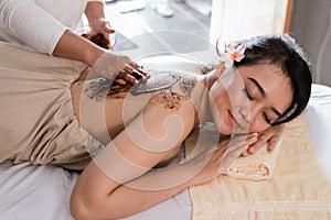 Woman in spa salon having spa therapy coffee scrub