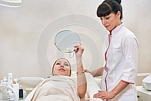 Woman in spa salon with mirror