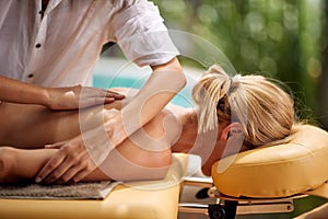 Woman at spa and wellness back massage treatment close up