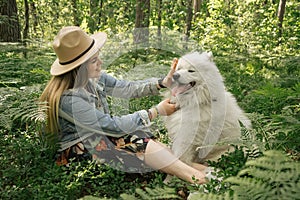 Woman spanding time with her fluffy dog samoyed